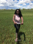 grad student conducting soil sample in field